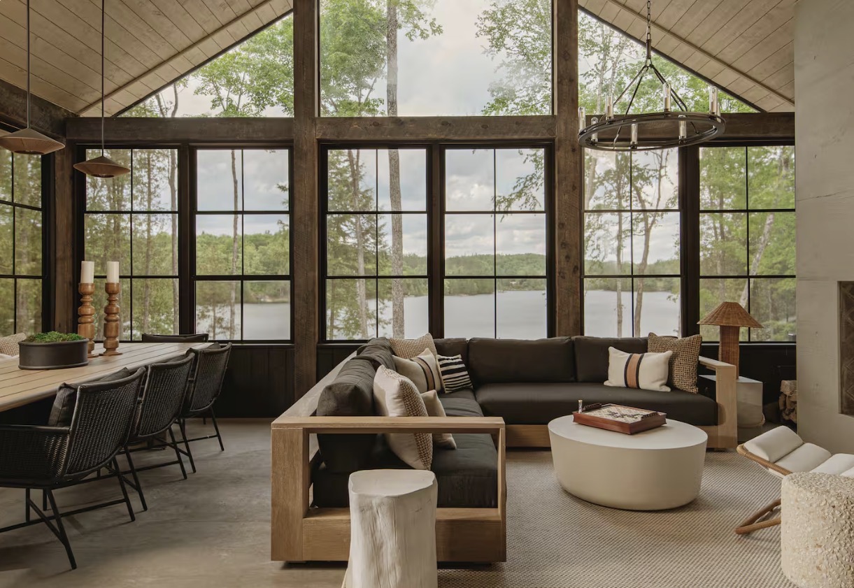 The great room at Sparrow Lodge with floor-to-ceiling windows over the lake