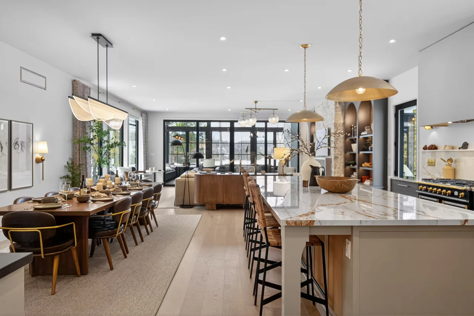The open kitchen with a marble island and long dining table