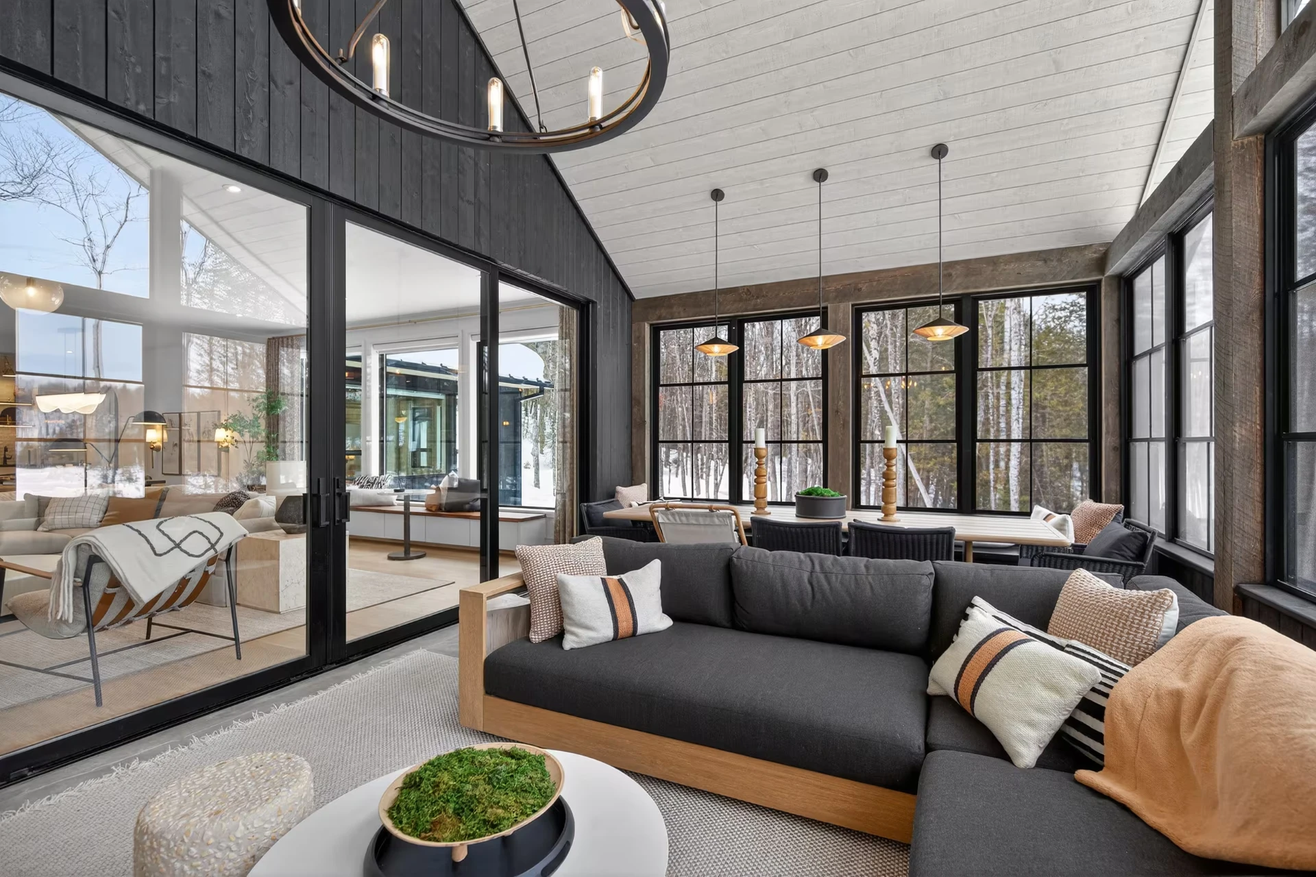 The sunroom, glassed on three sides and facing the trees
